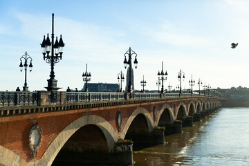 Fototapeta na wymiar Pont de pierre (Stone Bridge) on a bright sunny day, Bordeaux, France