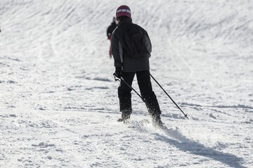 Fototapeta na wymiar Skier sliding down on hillside