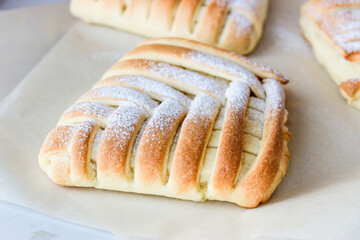 Sweet pastries in the shape of a square with an interesting pattern, stuffed with oranges and lemons,