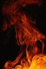 Orange smoke on a dark background. Intricate swirls of colored smoke. An abstract imitation of night flames.