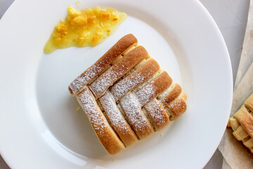 Sweet pastries in the shape of a square with an interesting pattern, stuffed with oranges and lemons,