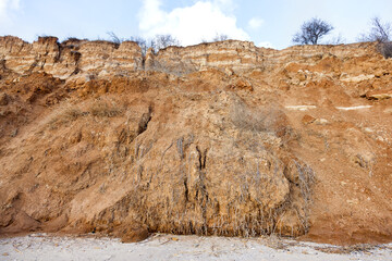 Rockslide. Mountain landslide in an environmentally hazardous area. Large cracks in earth, descent of large layers of earth blocking road. Mortal danger of dam at foot of landslide slopes of mountain