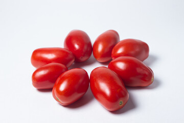 Tomatoes on a white background. Red tomatoes lie in the shape of a circle
