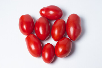Tomatoes on a white background. Red tomatoes lie in a pile