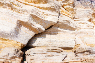 Background of mountain landslide in an environmentally hazardous area. Large cracks in the ground, the descent of soil layers, coquina. Deadly risk of coastal collapse