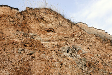 Background of mountain landslide in an environmentally hazardous area. Large cracks in the ground,...
