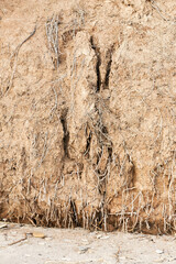 Background of mountain landslide in an environmentally hazardous area. Large cracks in the ground,...