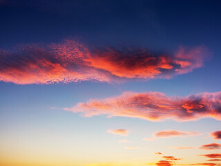 Setting Sun Sunset in the Sky. Sky blue and orange light of the sun through the clouds in the sky