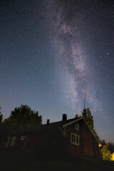 Milky Way above forest silhouette in clear dark night sky