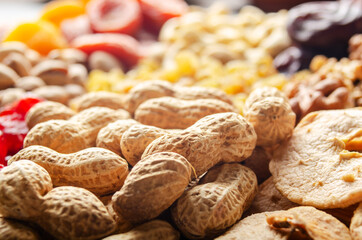 Fototapeta na wymiar Closeup view at peanut nuts on kitchen table. Vegetarian food concept