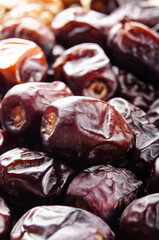 Pile of dried dates fruits on kitchen table. Healthy nutritious antioxidant natural sweeteners