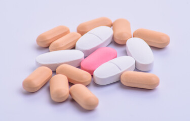 many white and pink pills close up view, stock photo