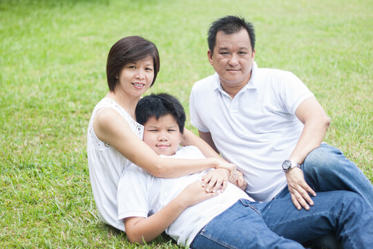 Asian Family Enjoying  Happy And Joyful Day Out In Outdoor Nature