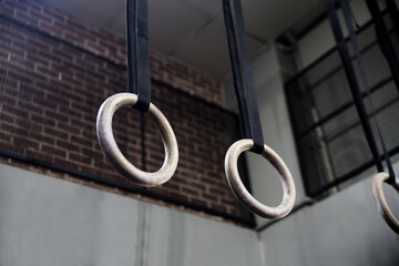 Gymnastic rings suspended on straps on crossfit gym