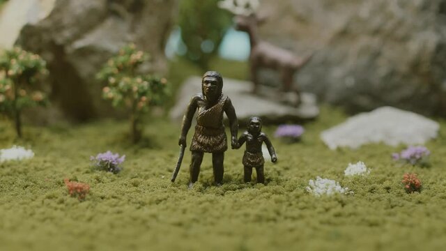 The Australopithecus family is standing in the middle of the forest