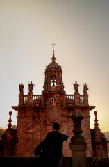 Man looking a church in the evening / Iglesia de San Frutuoso - Santiago de Compostela, Spain 