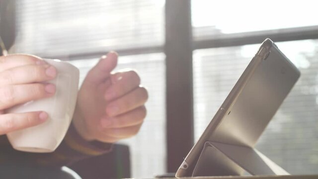 Man using tablet. Close up footage of person working on tablet.