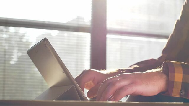 Man using tablet. Close up footage of person working on tablet.