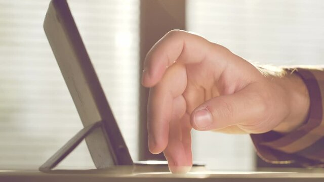 Man using tablet. Close up footage of person working on tablet.