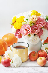 Autumn harvest pumpkin background. Pumpkins, apples and flowers on table. Thanksgiving table. Copy space. Halloween or seasonal autumnal. Design mock up. Greeting card. Fall kitchen.