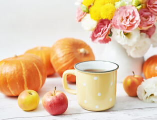 Autumn harvest pumpkin background. Pumpkins, apples and flowers on table. Thanksgiving table. Copy space. Halloween or seasonal autumnal. Design mock up. Greeting card. Fall kitchen.