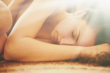 Obraz na płótnie Canvas Beautiful woman lying on the floor at home in the sun.