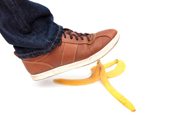 Leg of man  stepping on banana peel, concept picture