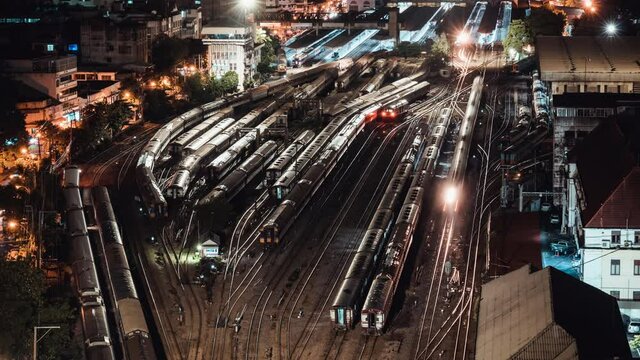 Time-lapse of old trains parking in rail yard at Hua Lamphong train station in Bangkok city, Thailand. Railway transportation concept. High angle view