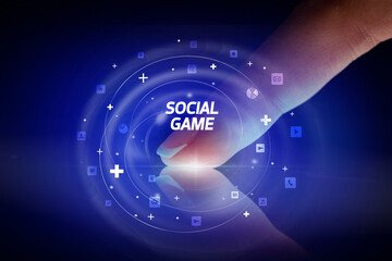 Finger touching tablet with social media icons and SOCIAL GAME