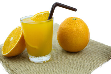 Orange fruite and juice in a glass put on hemp sack on the wih