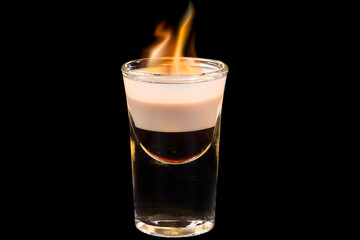 Amazing cocktail b-52 in a glass with flame,