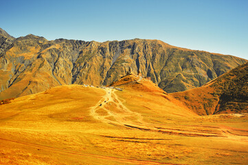 Fototapeta na wymiar Panoramic view of Mount Kazbek in the Caucasus Mountains of Georgia is not far from the village of Stepantsminda