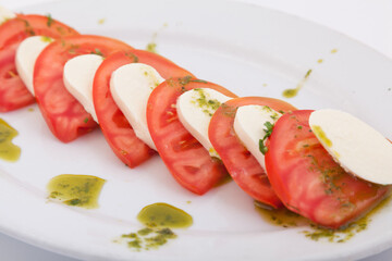 Close up of Italian Caprese Salad with Mozzarella Cheese, Tomatoes and Basil