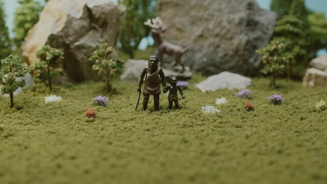 The Australopithecus family is standing in the middle of the forest