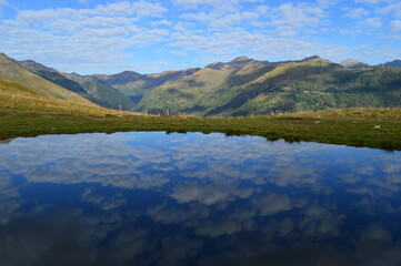 Reflections of the mountains around Lake Como in Lombardy, Northern Italy