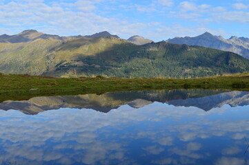 Reflections of the mountains around Lake Como in Lombardy, Northern Italy