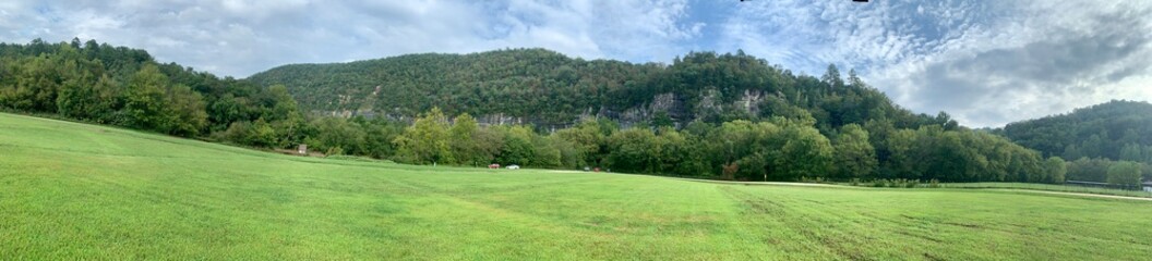 Panoramic landscape at the Steele River access to the Buffalo National River in Northwest Arkansas taken on a cloudy, rainy day.  Pretty grass and sky.