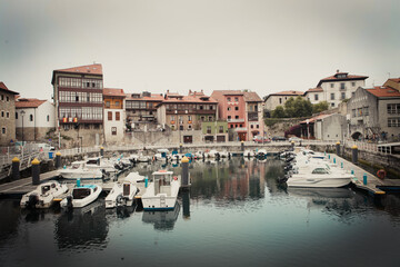 Fototapeta na wymiar Old picturesque town in Asturias with a small port full of boats