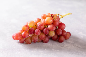 Bunch of grapes on light background. Red grapes