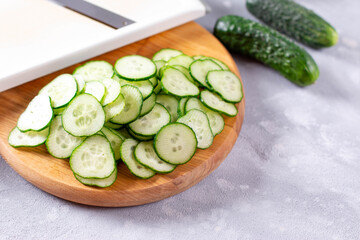 Fresh cucumber slices on a light background