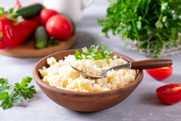 Couscous with parsley in the bowl. Concept of Healthy Food.