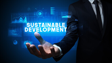 Hand of Businessman holding SUSTAINABLE DEVELOPMENT inscription, business success concept