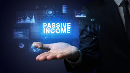 Hand of Businessman holding PASSIVE INCOME inscription, business success concept