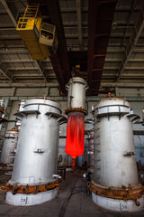 Melting metal titanium in vacuum furnace. Metallurgy factory workshop. Wide-angle lens.