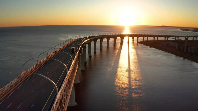 High-speed toll road, highway bypassing the city center St. Petersburg, the central section of the western high-speed section. A beautiful view of the sunset over the Gulf of Finland.