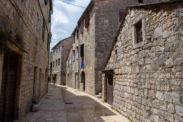 Stari Grad/ Croatia-August 7th, 2020: Traditional stone houses in narrow street, native to dalmatian region of Croatia, famous tourist attraction for sightseeing