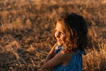 Portrait of Young girl while playing happily in the field