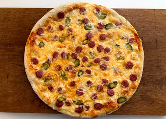 pizza with cabanos sausage on wooden board