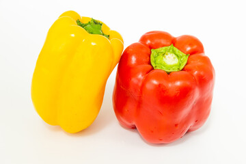 Obraz na płótnie Canvas yellow and red fresh bell peppers, on white background