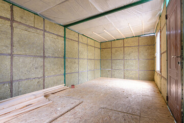 The interior of a suburban room under construction, insulated from the inside with soft thermal insulation